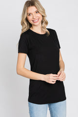 woman wearing a black short sleeve t-shirt paired with light blue jeans
