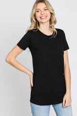 smiling woman wearing a black short sleeve crew neck t-shirt and blue jeans