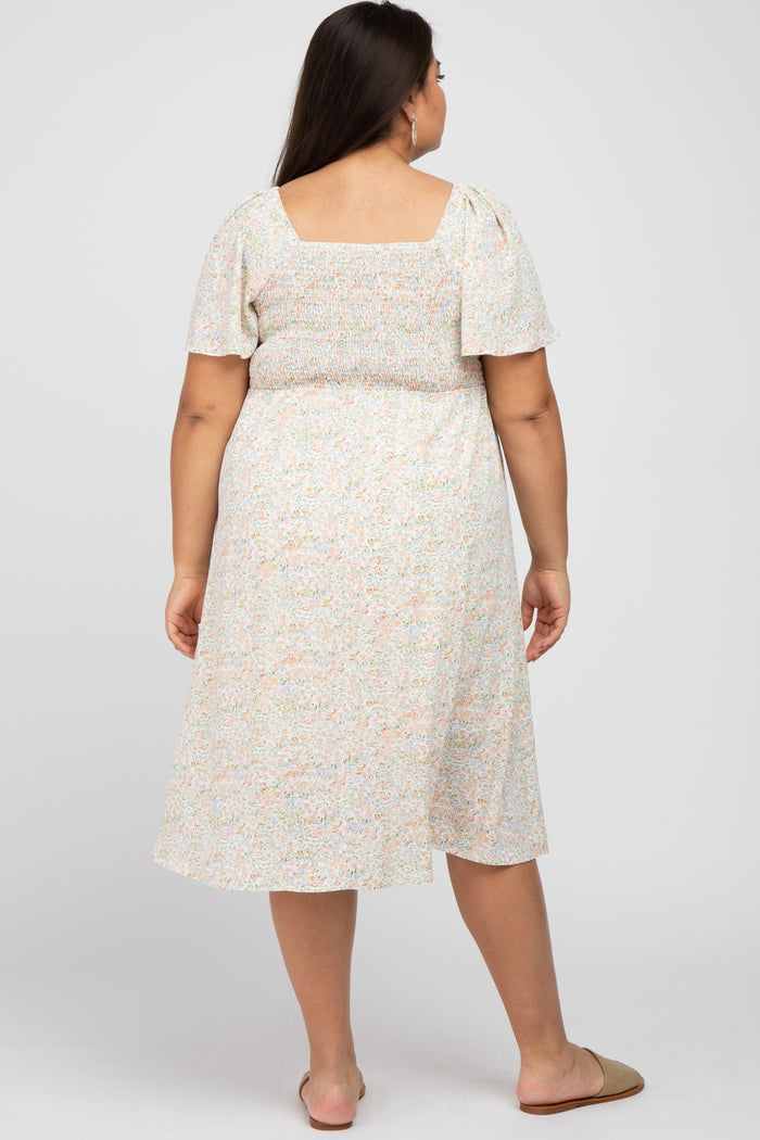 woman wearing a floral print plus-size midi dress with short sleeves and a smocked bodice, viewed from the back