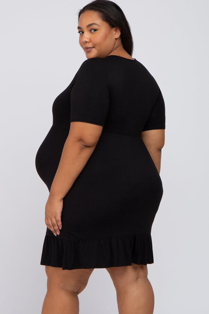 woman wearing a black short sleeve maternity dress with a ruffle hem and a visible baby bump