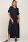 woman wearing a navy blue short sleeve button-down maxi dress with side slits and a chest pocket