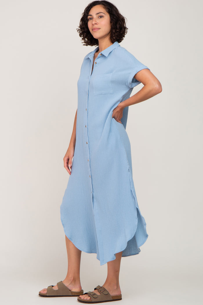 woman wearing a light blue button-up midi dress with short sleeves and side slits