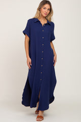 woman wearing a navy blue button-up maxi dress with short sleeves and a side slit