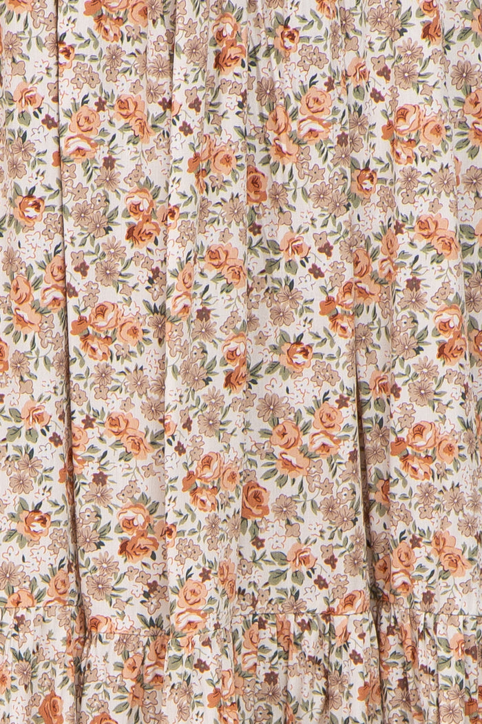 floral print fabric in soft peach and beige hues with gathered ruffle detailing