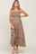 woman wearing a brown floral maternity maxi dress with adjustable straps and a visible baby bump