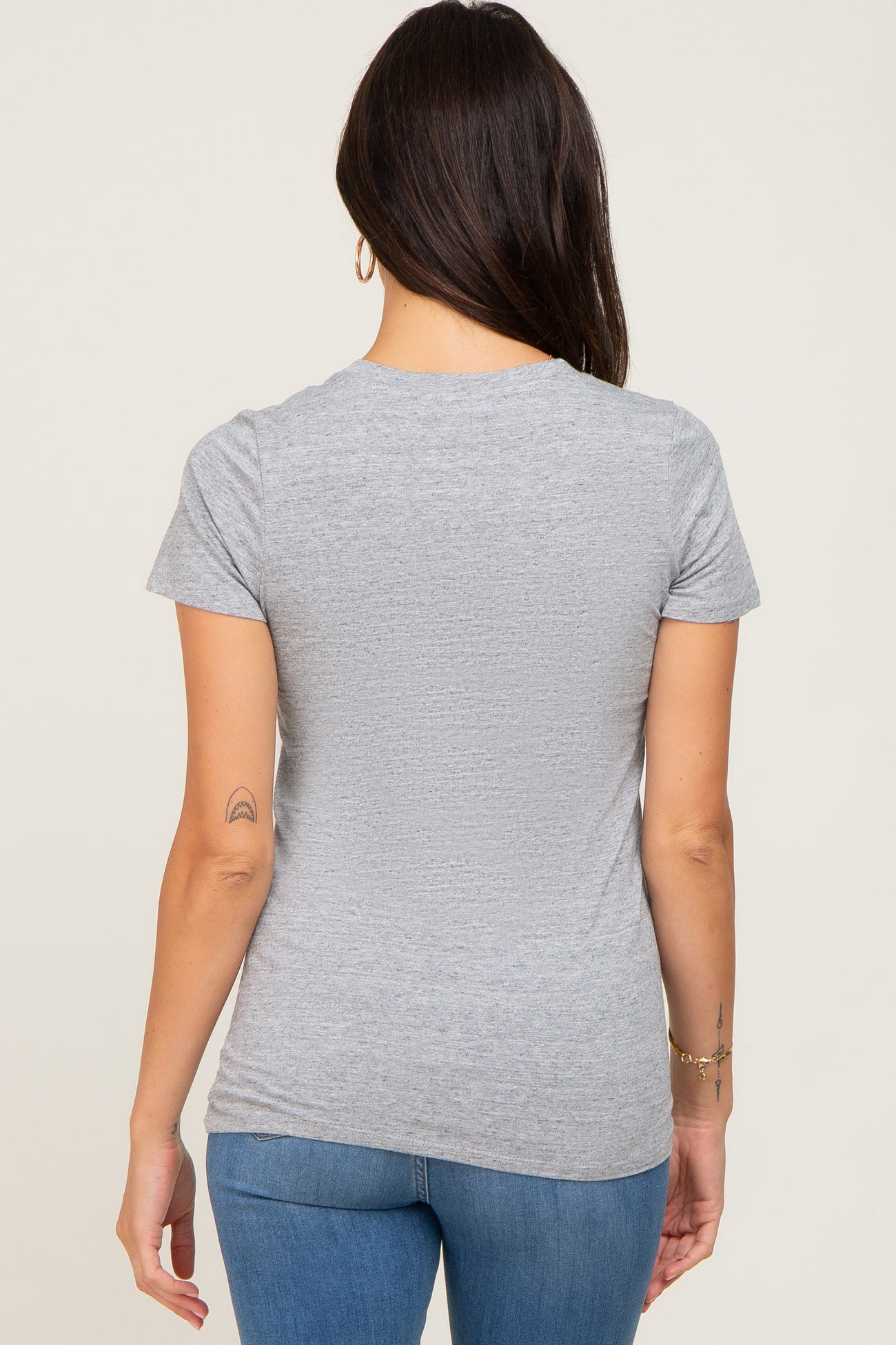 woman wearing a gray short sleeve t-shirt from the back, with a casual fit and soft fabric