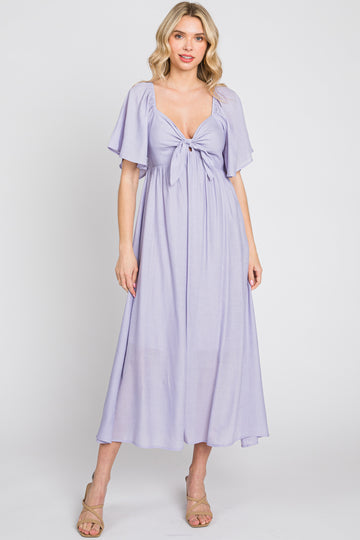 woman wearing a lavender maxi dress with a tie front and short flutter sleeves