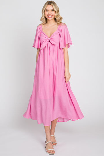 woman wearing a pink midi dress with flutter sleeves and a tied front detail