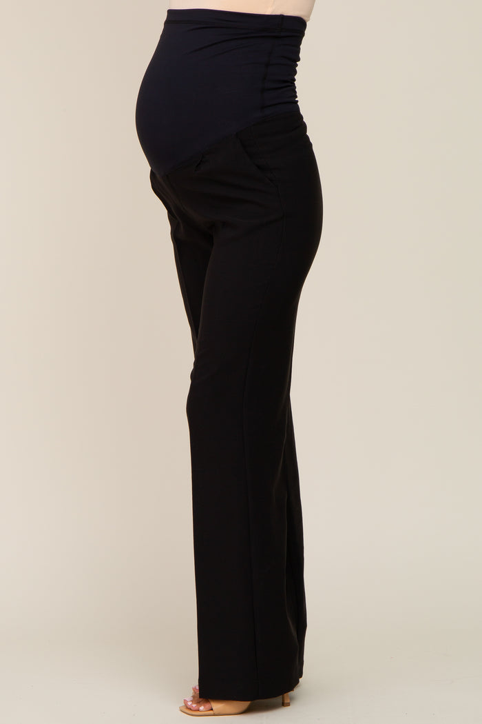 woman wearing black maternity pants with a stretchy waistband and visible baby bump