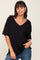 woman wearing a black v-neck short sleeve t-shirt and blue jeans