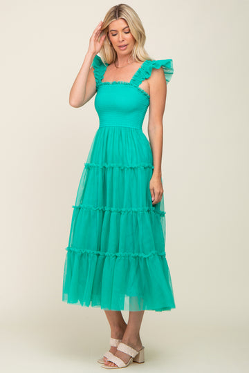 woman wearing a turquoise tiered maxi dress with ruffle straps and smocked bodice