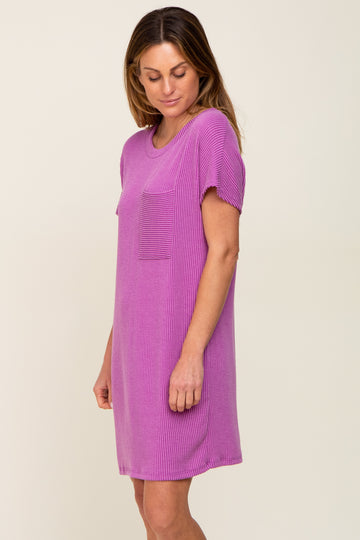 woman wearing a short sleeve ribbed pink dress with a pocket on the chest