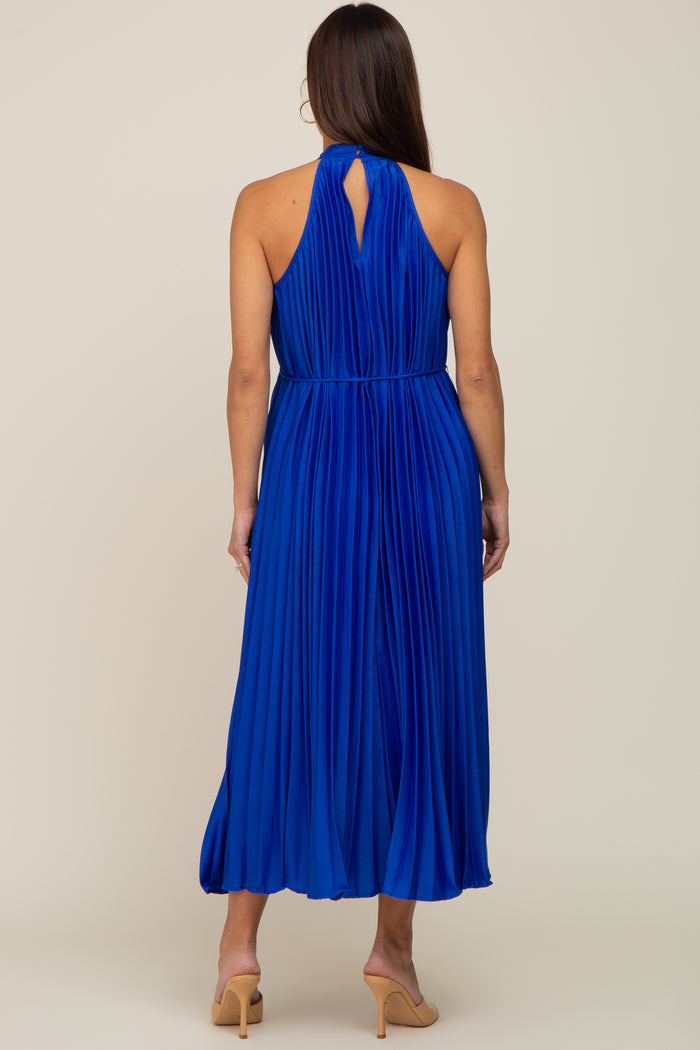 woman wearing a pleated royal blue maternity dress with a keyhole back detail