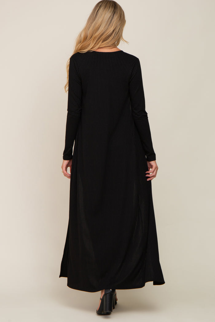 maternity wear black ribbed maxi dress with long sleeves and side slits, worn by a model seen from the back