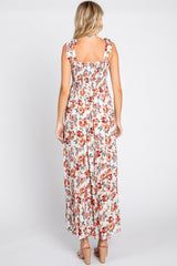 woman wearing a floral maxi dress with ruffle straps and a smocked back, shown from the back