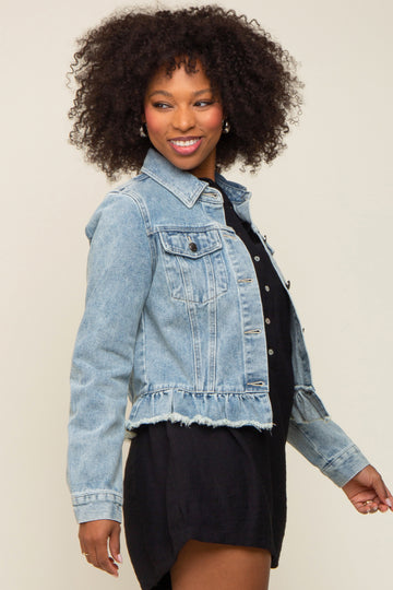 woman wearing a light blue denim jacket with frayed hem and styled with a black dress
