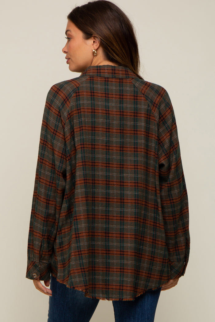Back view of a woman wearing a brown and green plaid flannel shirt with a raw hem and raglan sleeves