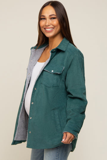 woman wearing a teal corduroy maternity jacket with grey lining and a visible baby bump