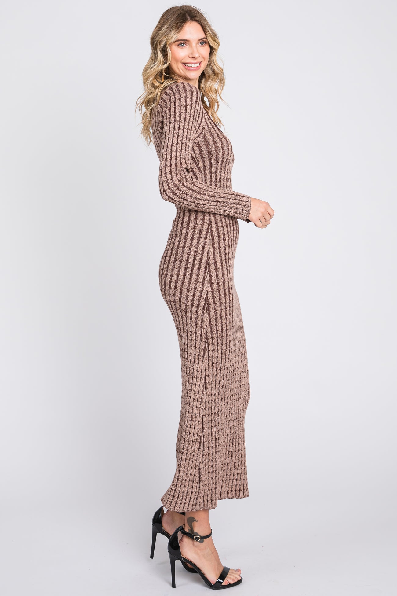woman wearing a ribbed brown long sleeve maxi dress and black heeled sandals, posing in profile