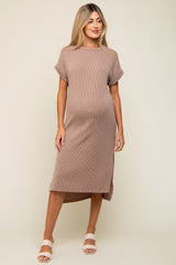 woman wearing a taupe ribbed maternity dress with short sleeves and a side slit, showcasing her baby bump