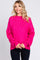 woman wearing a bright pink oversized sweater with long sleeves and a relaxed fit