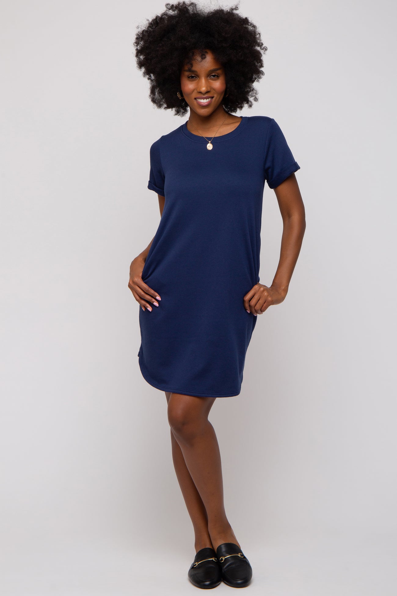 woman wearing a navy blue short sleeve casual dress with side pockets and a relaxed fit