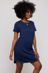 woman wearing a navy blue short sleeve t-shirt dress with a relaxed fit and side slits