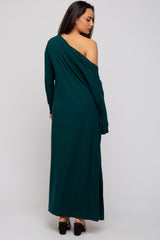 woman wearing a dark green ribbed maxi dress with one shoulder exposed and a side slit