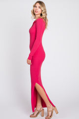 woman wearing a fuchsia long sleeve ribbed maxi dress with side slits and strappy beige heels