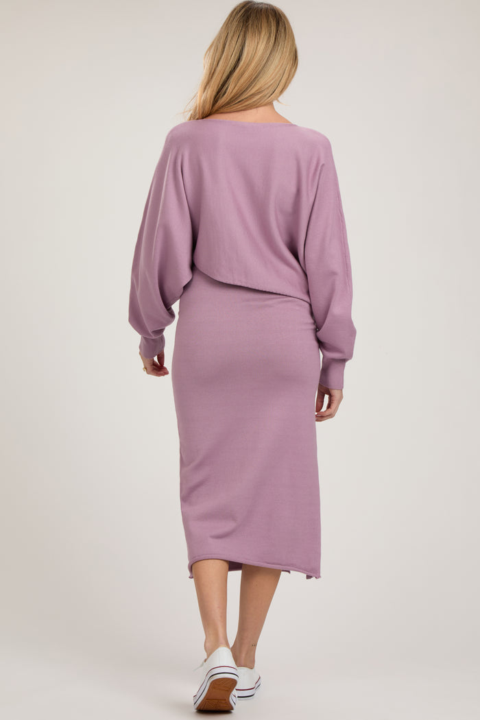 woman wearing a light purple maternity sweater dress with long sleeves, shown from the back