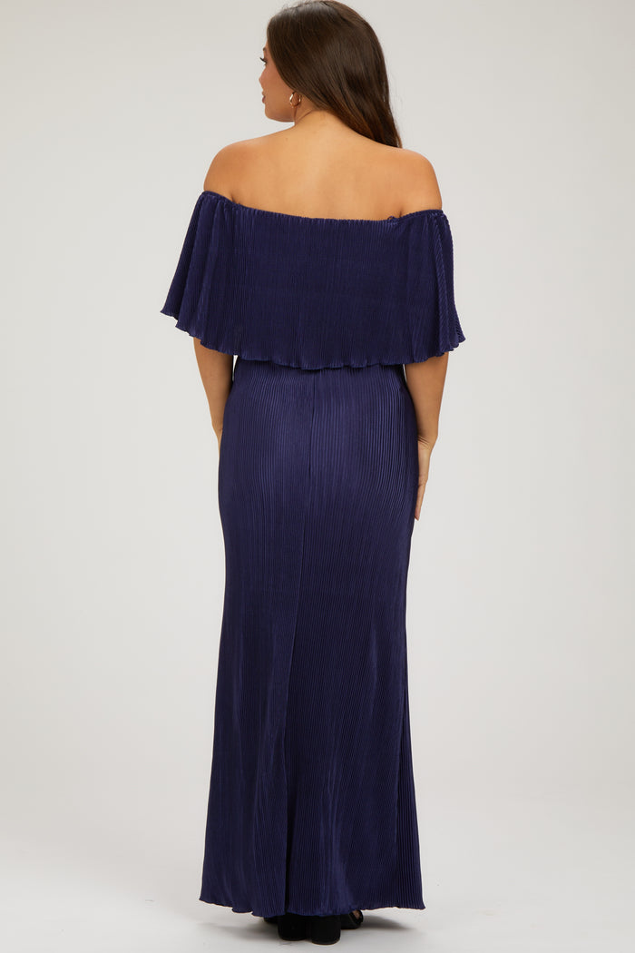 woman wearing a navy off-the-shoulder maternity gown with a flowy top and fitted skirt, showing a flattering silhouette