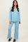 woman wearing a light blue ribbed loungewear set with a v-neck long sleeve top and wide leg pants