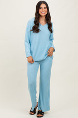 woman wearing a light blue ribbed long sleeve top and matching wide-leg pants