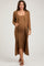 woman wearing a brown ribbed maternity dress with a long cardigan and showing her baby bump