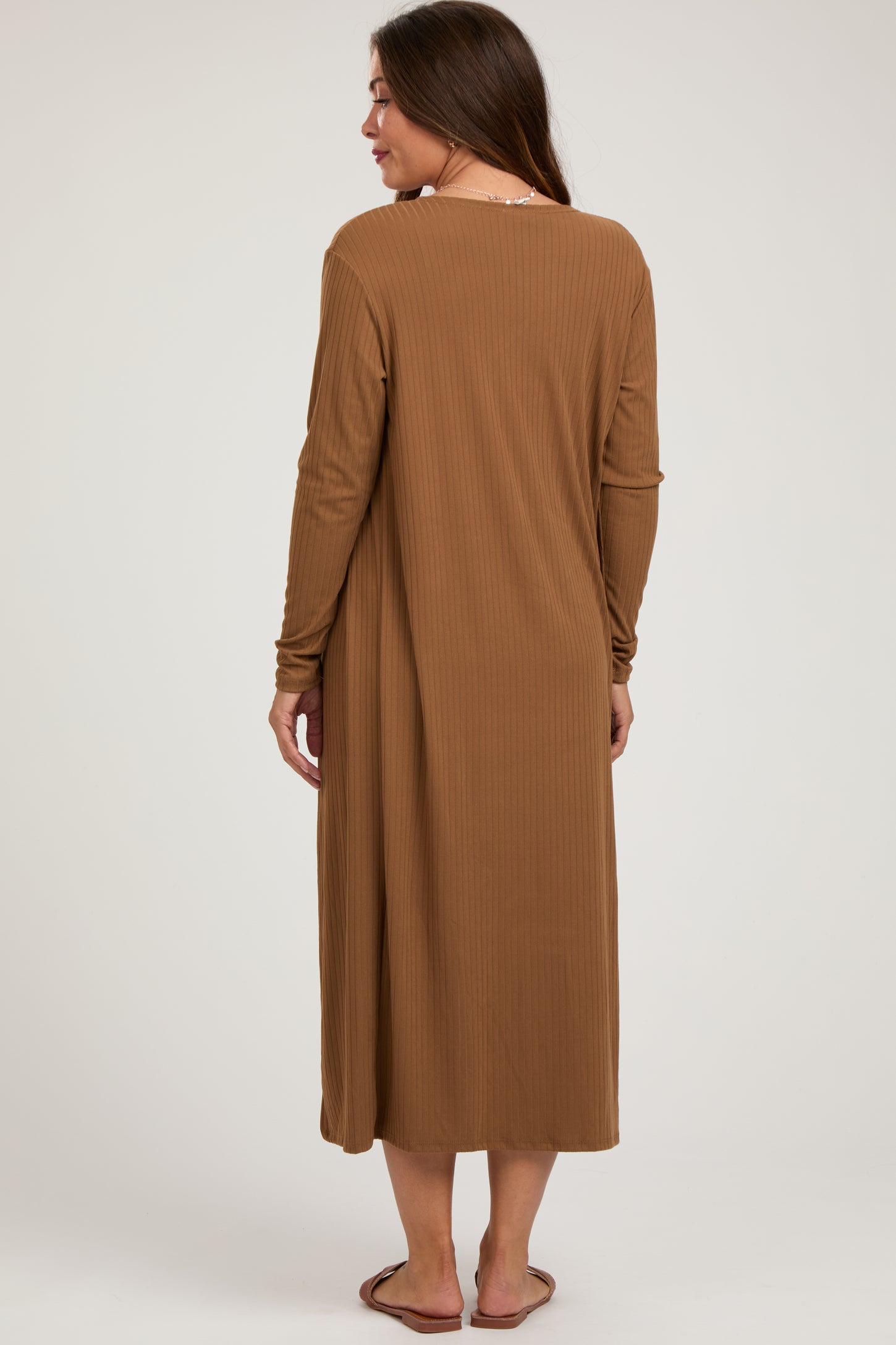woman wearing a brown long sleeve maternity dress with a relaxed fit, view from the back
