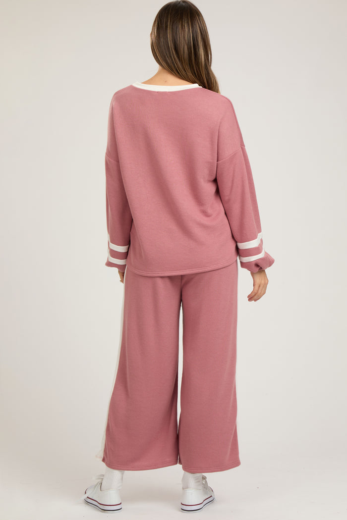 woman wearing a pink maternity lounge set with wide-leg pants and long sleeve top, casual style from the back
