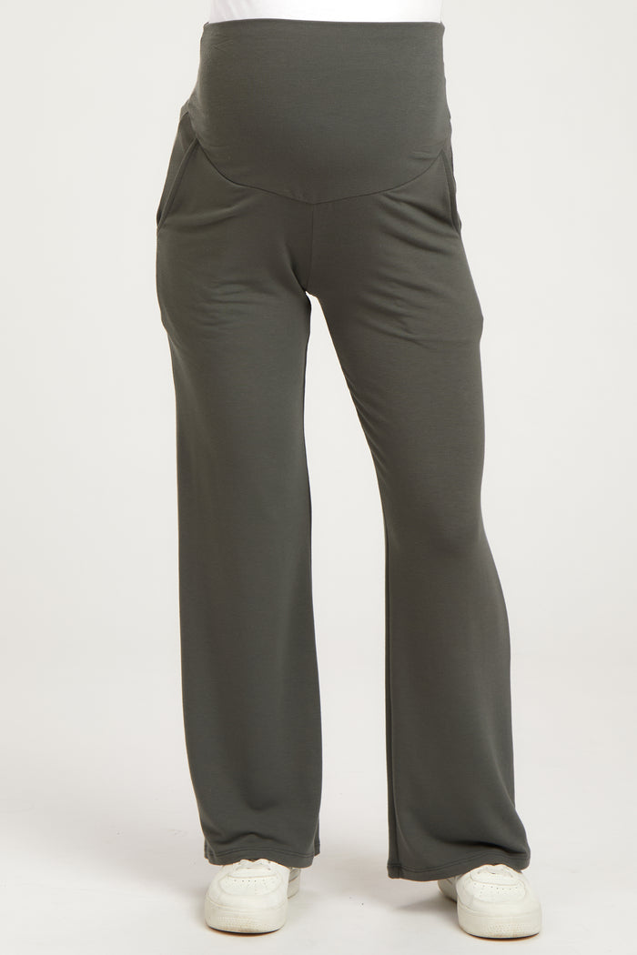 woman wearing gray maternity pants with a supportive waistband and side pockets