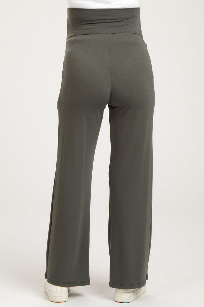 woman wearing olive green maternity pants with a high waistband and wide leg style, viewed from the back