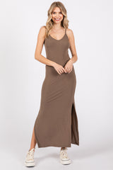 woman wearing a brown ribbed maxi dress with a side slit and spaghetti straps