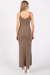 woman wearing a brown ribbed maxi dress with spaghetti straps and side slits, shown from the back