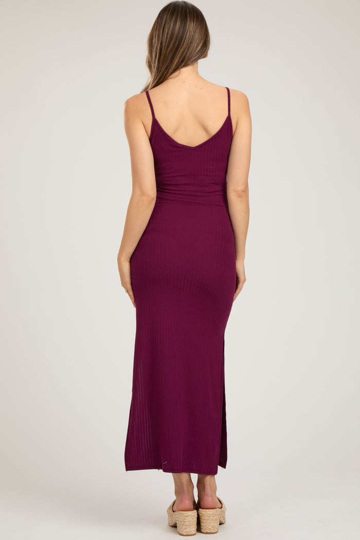 woman wearing a maroon ribbed maternity maxi dress with a fitted silhouette and side slit