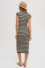 woman wearing a black and cream striped midi dress with cap sleeves and a straw hat