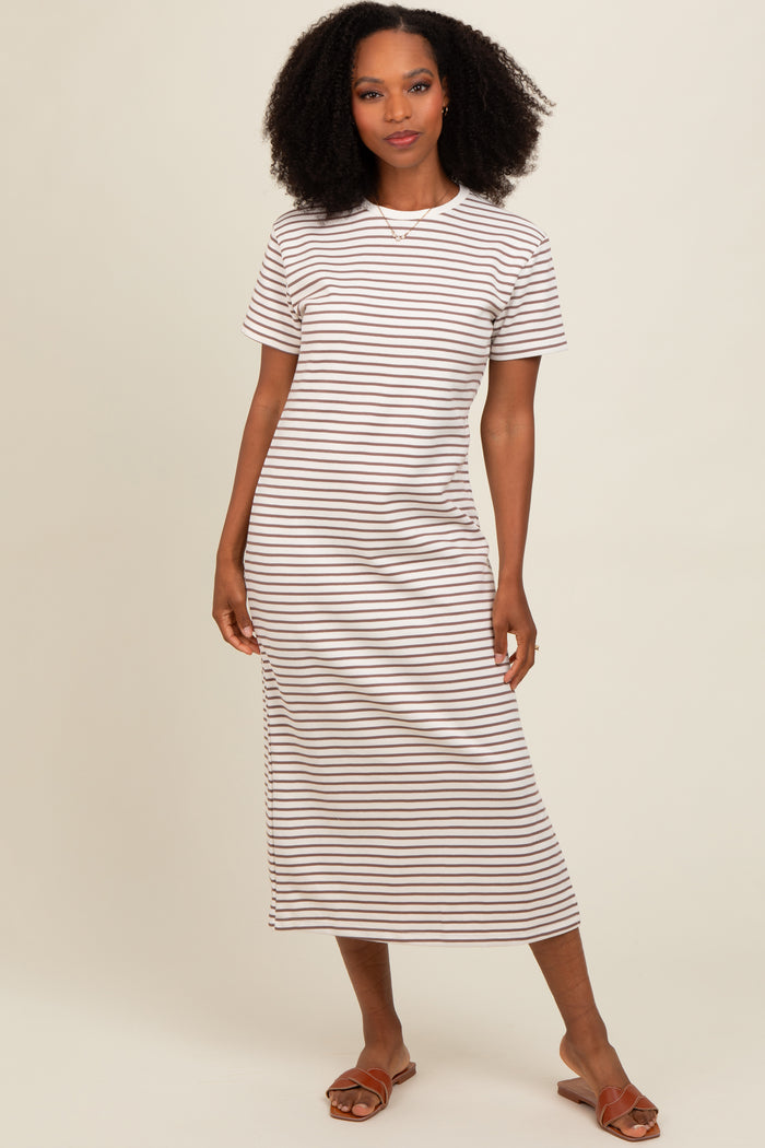 woman wearing a short sleeve striped midi dress in cream and brown with side slit and brown sandals