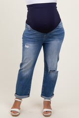 woman wearing dark blue maternity plus jeans with a high waist, featuring distressed details and rolled cuffs, showing a baby bump
