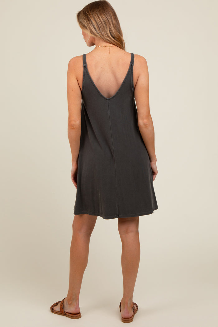 woman wearing a dark gray sleeveless maternity dress with a v-back design, shown from the back