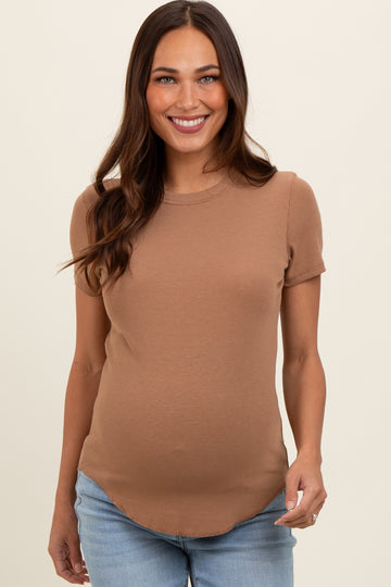 woman wearing a brown short sleeve maternity top and showing her baby bump