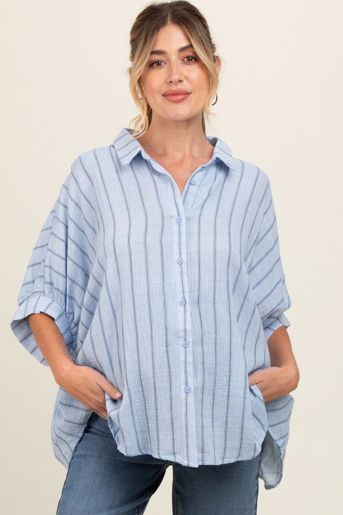 woman wearing a light blue striped maternity top with a button-up front and relaxed fit