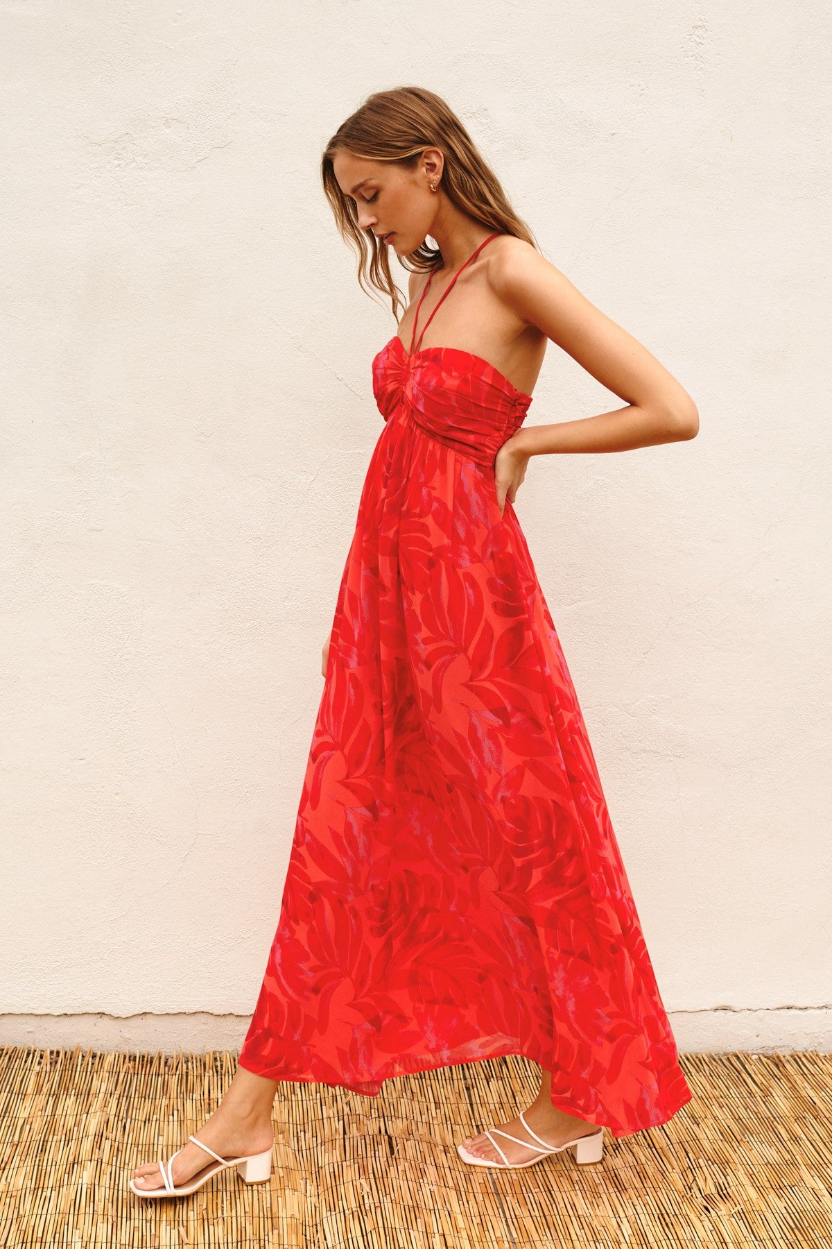 woman wearing a red floral maxi dress with a smocked bodice and spaghetti straps