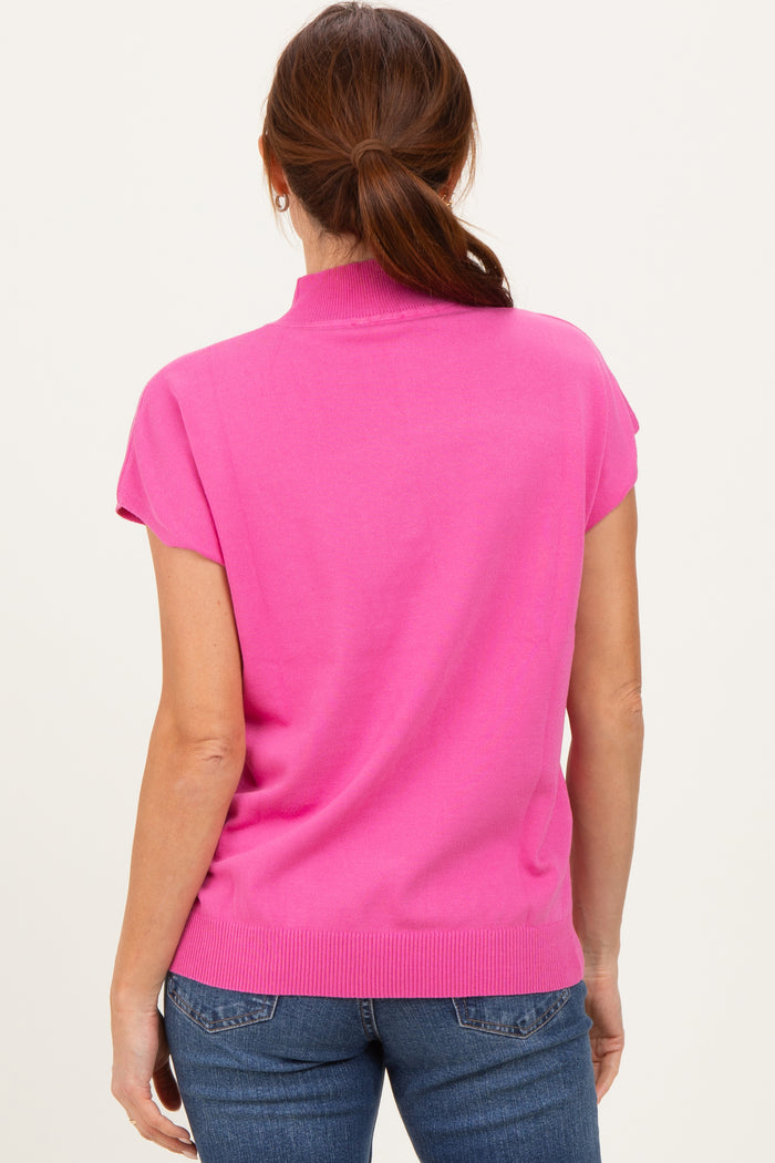 woman wearing a bright pink short sleeve sweater with a high neckline, viewed from the back
