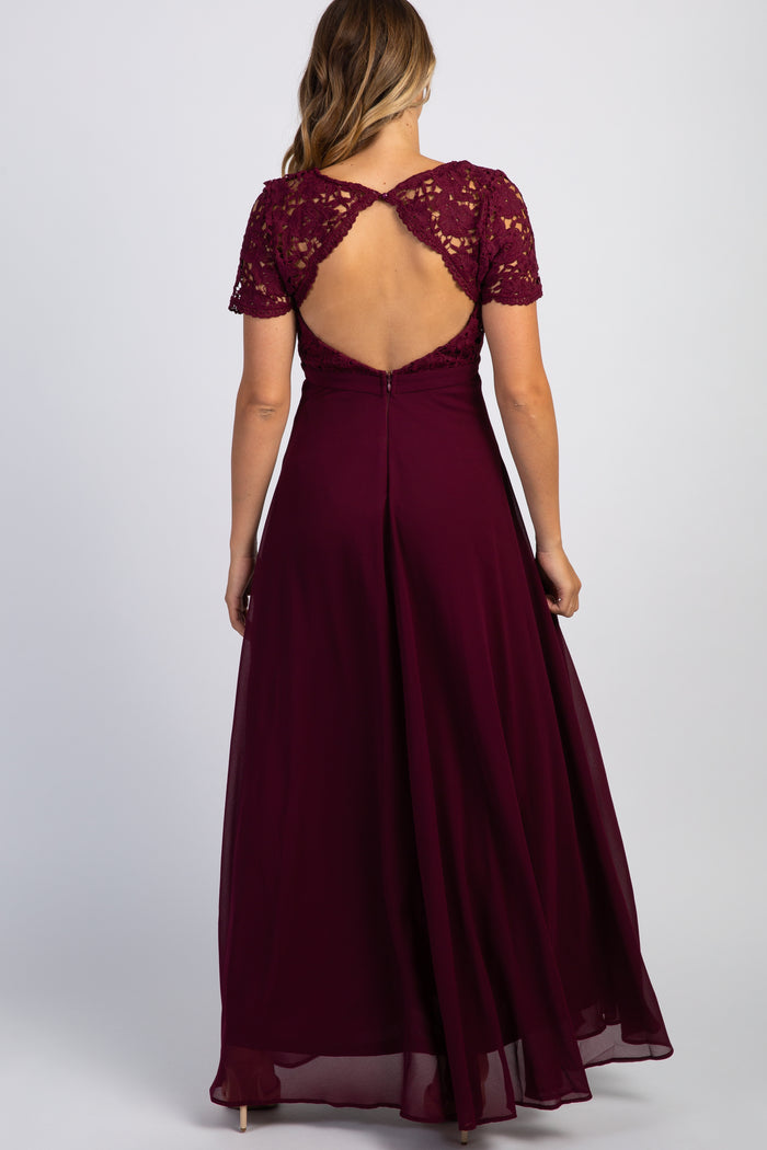 Back view of a woman wearing a burgundy maxi dress with a lace bodice and open back cutout